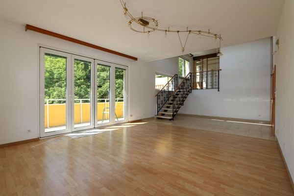 Wohn-/Esszimmer mit Galerie und Zugang zum Balkon
