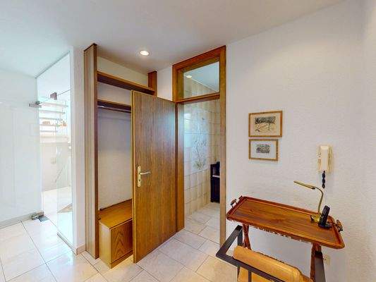 Praktische Garderobe mit direktem Zugang zum Gäste-WC im Erdgeschoss.