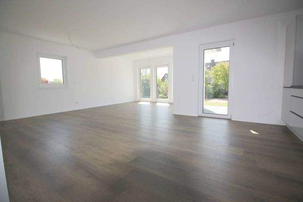 Blick in den Wohnbereich mit bodentiefen Fenstern u. Terrassenzugang