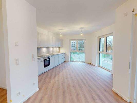 Ansicht II: Wohnzimmer mit Blick in die Küche