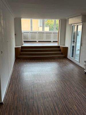 Lichtdurchfluteter Wohnbereich mit eleganter Ebenengestaltung und Balkonzugang - Moderne Raumarchitektur mit Wohlfühlfaktor!