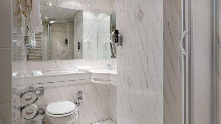 Zeitgemäß ausgestattete Badezimmer mit Waschtisch und Dusche