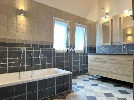 Bathroom with bathtub, shower, double washbasin