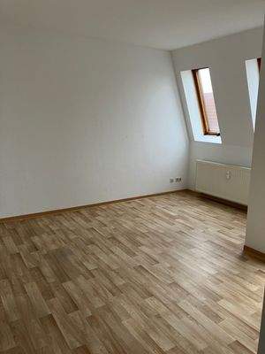 Wohnbereich mit weißen Wänden, Fenstern und PVC Boden in Holzoptik