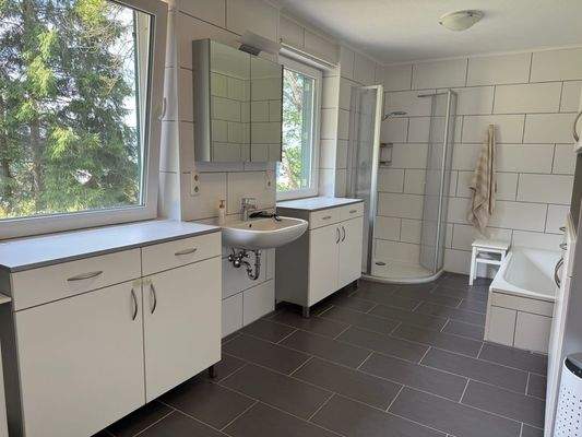 Großzügiges Badezimmer mit Wanne und Dusche 