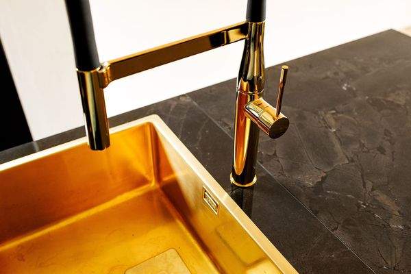 Goldene Spüle mit Armatur