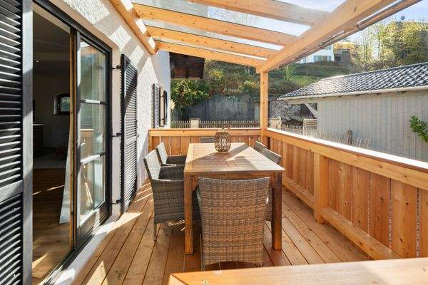 Mit Glas überdachter Westbalkon