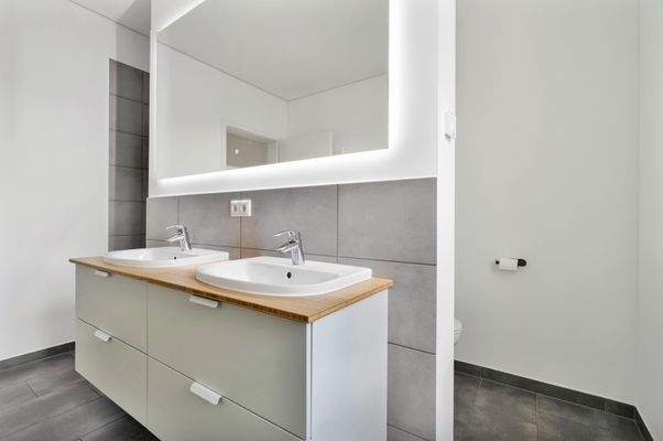 Elegantes Tageslichtbad mit ebenerdiger Dusche, Badewanne und Doppelwaschbecken