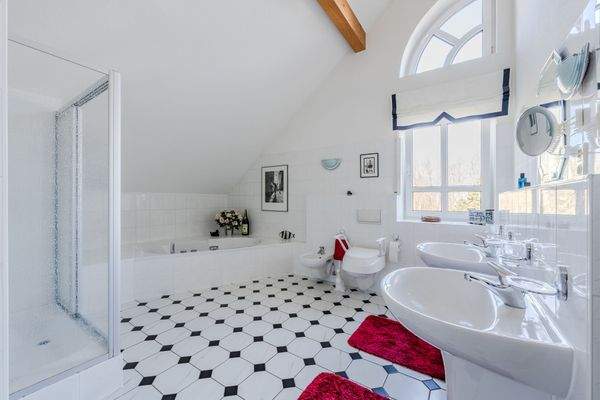 Spacious bathroom with natural light and bathtub