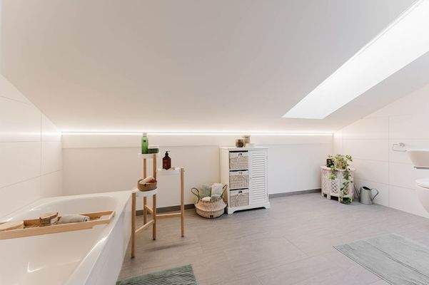 Das Tageslicht-Badezimmer mit Badwanne im Dachgeschoss 