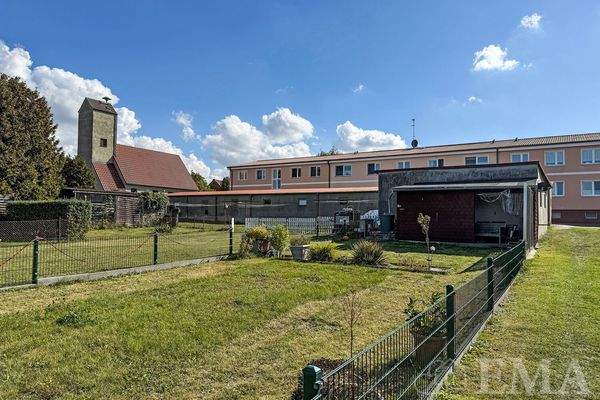 Blick vom Garten zur Wohnanlage