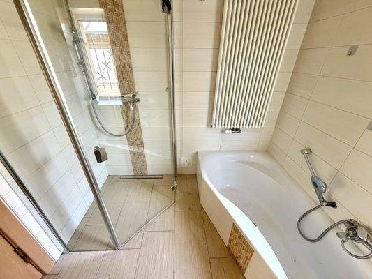 Badezimmer mit Badewanne und Dusche