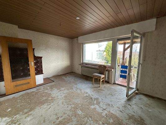 Wohnzimmer mit Kachelofen und Zugang zur Terrasse/Garten