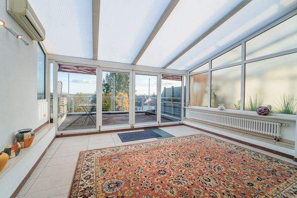 Lichtdurchfluteter Wintergarten mit Terrassenzugang