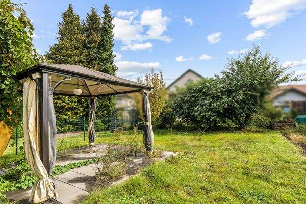 Gartenfläche mit überdachtem Freisitz