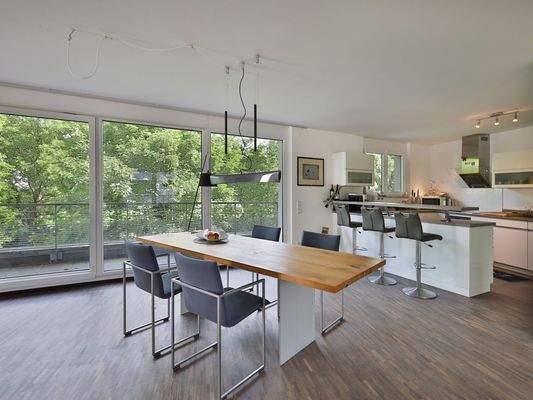 Heller Essbereich mit Blick ins Grüne und zur offenen Küche