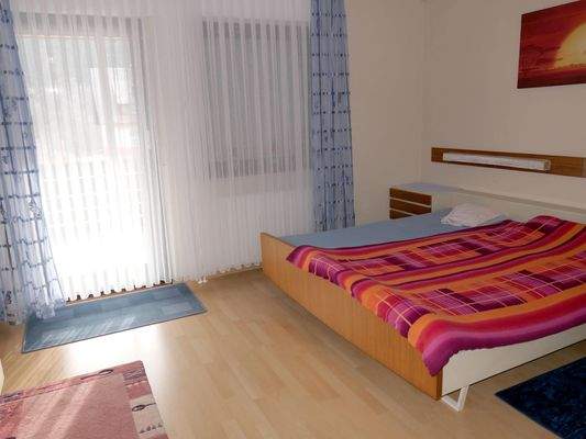 Schlafzimmer mit Zugang zum Balkon im OG