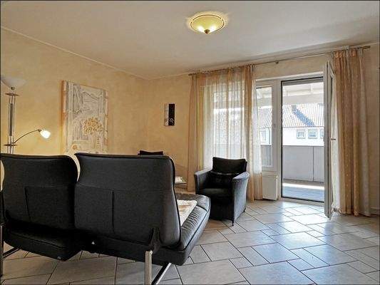 OG: Großer Wohnbereich mit überdachtem Balkon