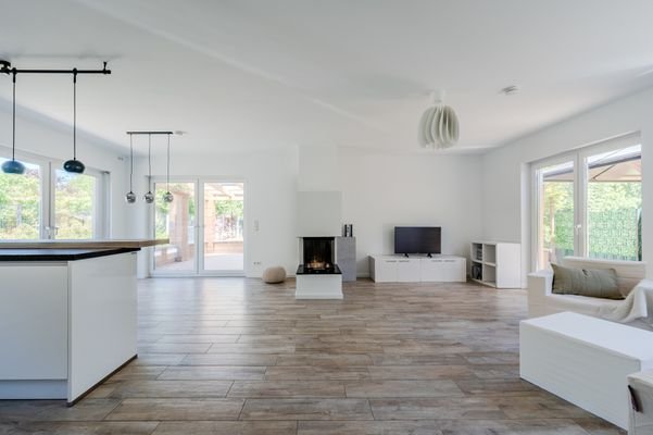 Large living/ dining and kitchen area with firepla