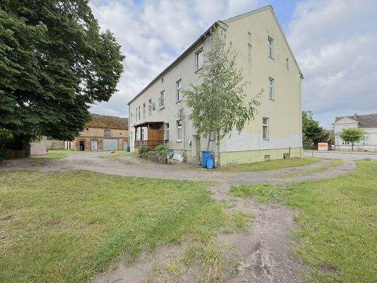 unbefestigter Innenhof mit zwei Grundstückszufahrten