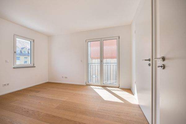 Schlafzimmer mit bodentiefen Fensterflächen und Zugang zum Bad en Suite