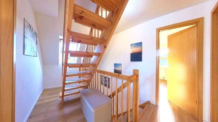 Helle Dachgeschoss-Diele mit elegantem Aufgang zum wohnlich ausgebauten Spitzboden