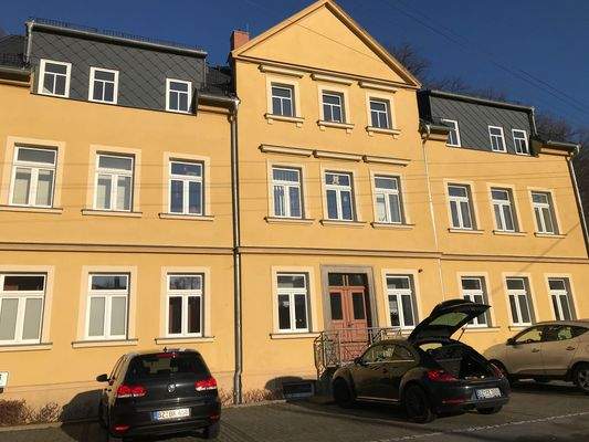 Gelbes Wohnhaus mit Autos