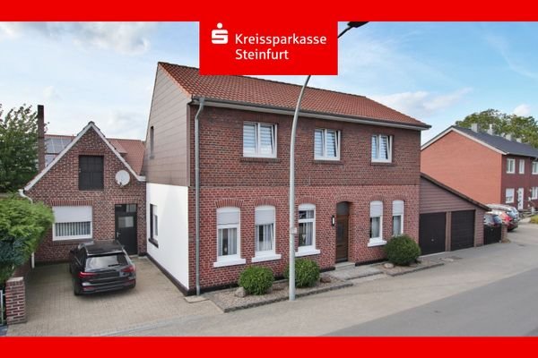 Straßenansicht mit Werkstatt und Doppelgarage