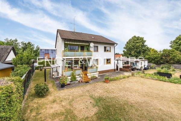 Südansicht der Immobilie - Blick in den Garten mit Freisitz, Gemüsebeet und viel Platz für Kinder