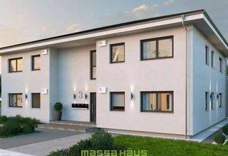 Modernes, hellgraues massa haus Fertighaus mit mehreren Wohneinheiten und separaten Eingängen, ideal