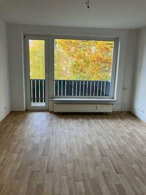 Wohnzimmer mit Panoramafenster und Zugang zum Balkon.jpg