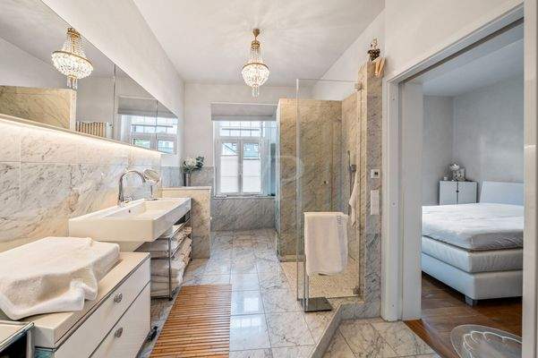 Elegantes Marmor-Badezimmer mit ensuite Zugang zu einem weiteren Schlafzimmer