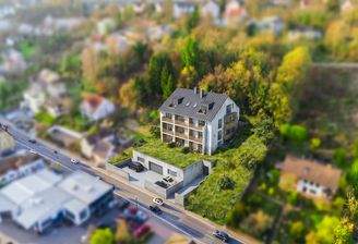 Visualisierte Darstellung der geplanten Mehrfamilienwohnanlage mit Tiefgarage auf dem angebotenen Baugrundstück