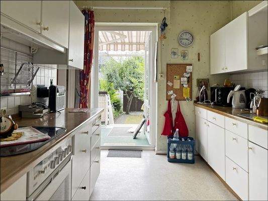 Gemütliche Küche mit Gartenzugang und überdachter Terrasse