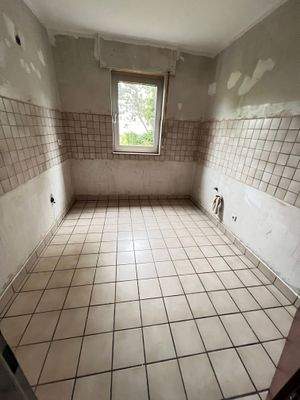 Küche mit beigen Wand- und Bodenfliesen