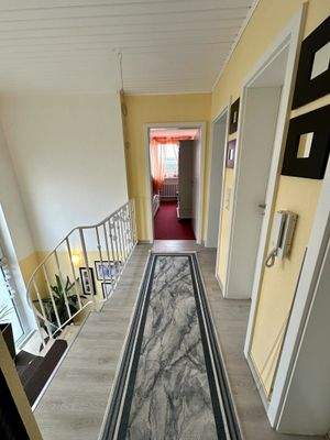 Eleganter Wohnungsflur mit geschwungener Treppe und Design-Läufer - Lichtdurchfluteter Verbindungsbereich mit charmantem Raumgefühl