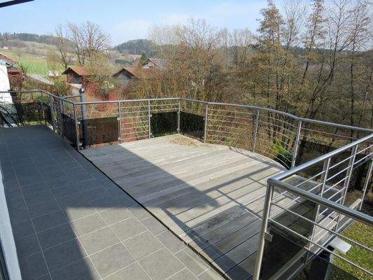 Terrasse mit Holzbelag und Edelstahlgeländer 