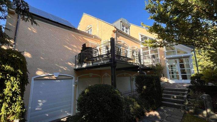 Außenansicht mit Blick auf Terrasse des Erdgeschosses und den Ausgang des Wellnessbereichs