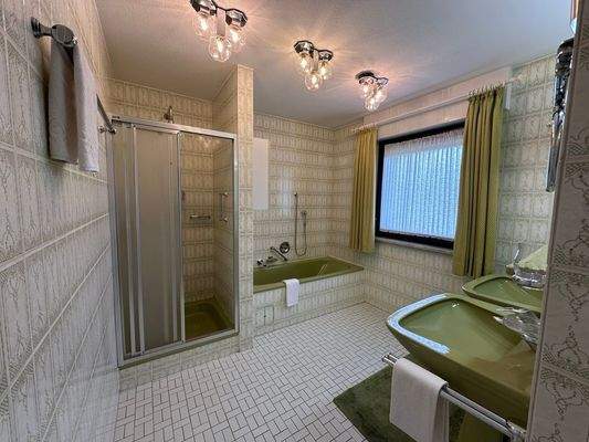 Zusätzliches Bad mit zwei Waschtischen und Badewanne.