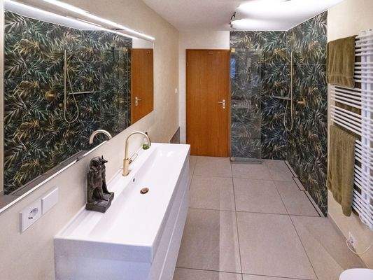 Stilvolles, modernes Badezimmer mit bodengleicher Dusche und WC