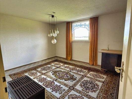 Wohnzimmer mit Kachelofen im DG