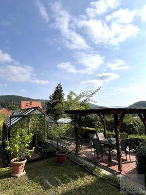 Überdachter Sitzplatz und Gewächshaus