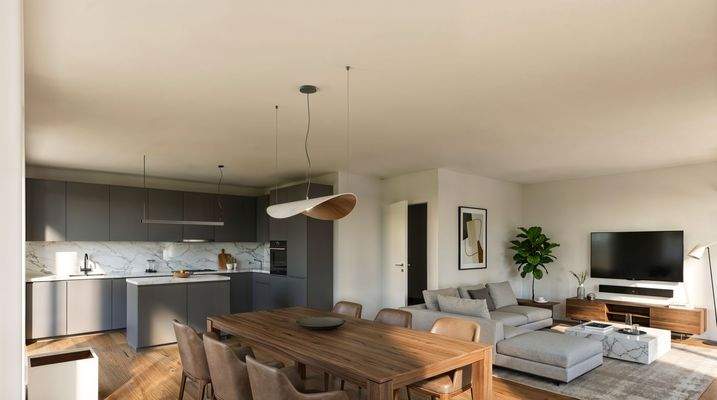 Das helle, moderne Wohnzimmer mit offener Küche besticht durch dunkle Möbel und einladende Atmosphäre