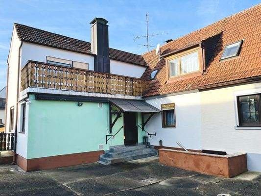 Nordostansicht mit Hauszugang und Balkon