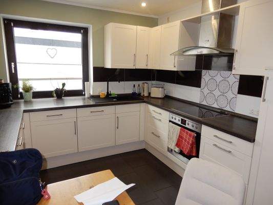 Helle offene Einbauküche mit Fenster