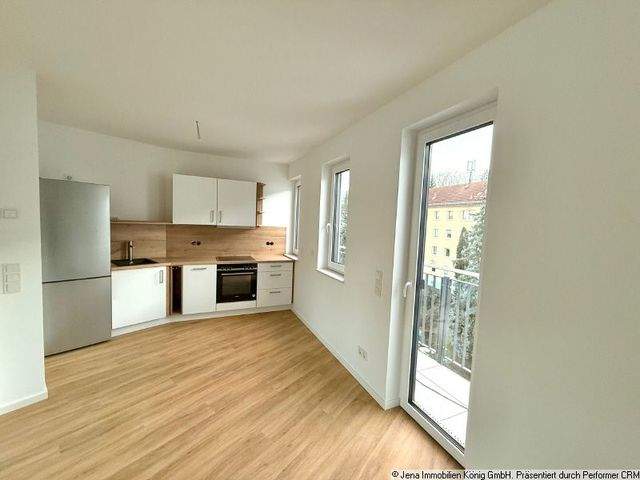 Erstbezug! Zentrumsnahes Einzimmerapartment mit Balkon, Einbauküche und Kamin - Photo 2