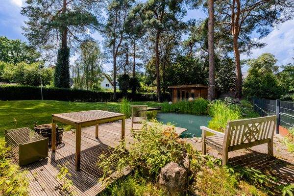 Idyllic terrace by the garden pond