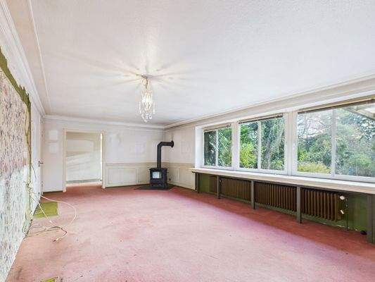 Wohnzimmer mit Kaminofen - Lütt Immobilien - Gadendorf