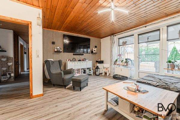 Wohnbereich mit TV-Wand und Zugang zur Terrasse