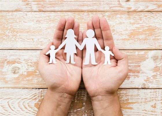 person-holding-paper-family-hands